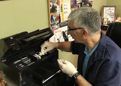 Dr. David fixing the printer at Williamsport West Veterinary Hospital